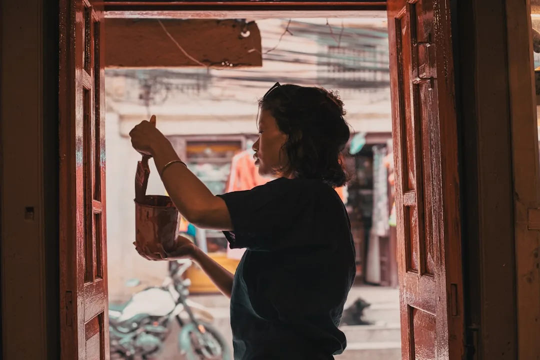 woman practicing hand weaving in home studio